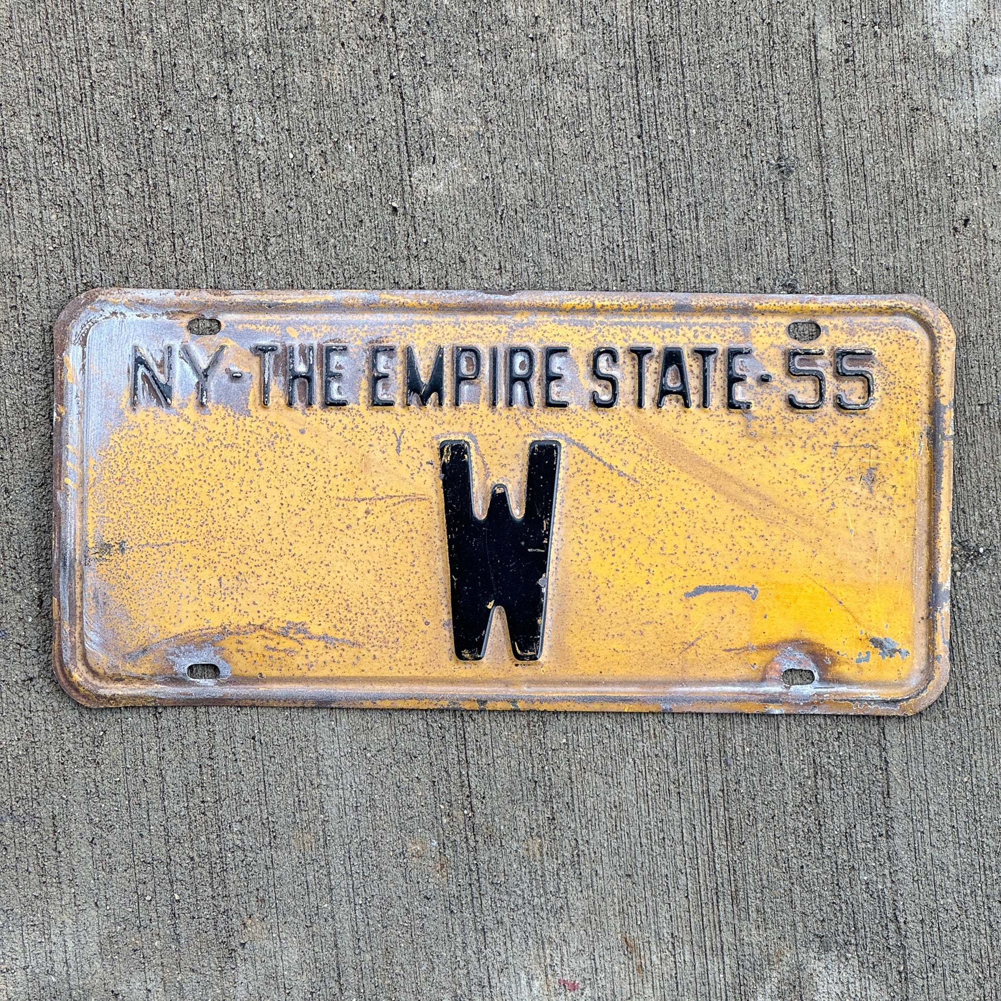 Photo of a 1955 New York Reserved License Plate Auto Tag Garage Decor Vintage Single Letter W with original patina