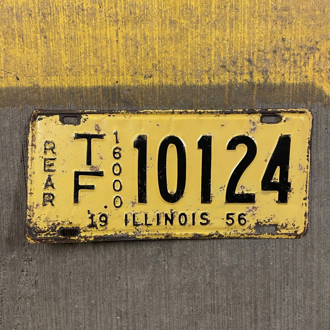 Photo of a 1956 Illinois Truck Mileage Tax License Plate Auto Tag Garage Decor Vintage Rear TF 10124 with original patina