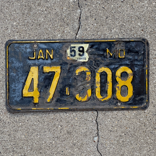 Image of a 1956 Missouri License Plate number 47 308 on a concrete background.
