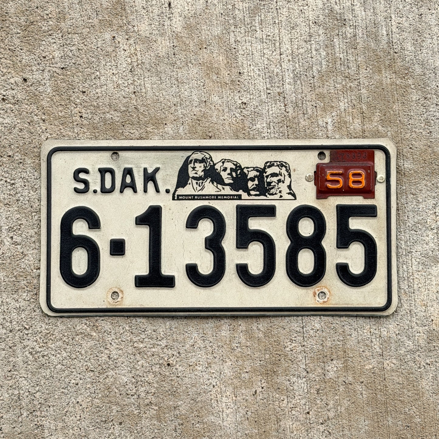 Photo of a 1957 1958 South Dakota License Plate Auto Tag Garage Decor Vintage Mt. Rushmore 6 13585 with original patina
