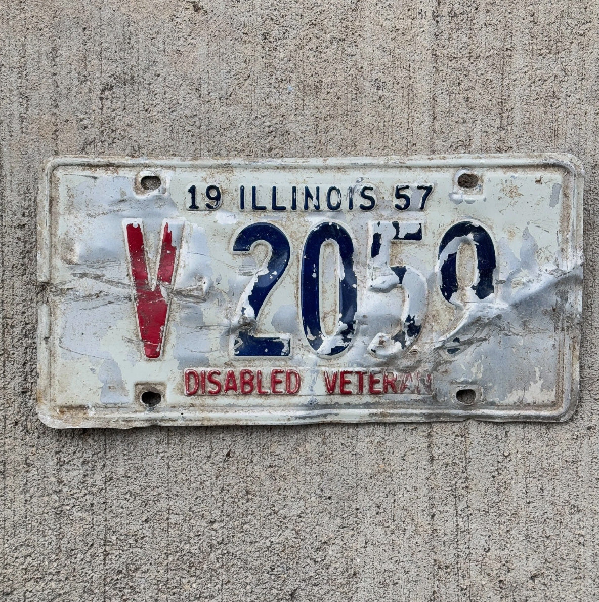 Photo of a 1957 Illinois Disabled Veteran License Plate Auto Tag Garage Decor DAV V 2059