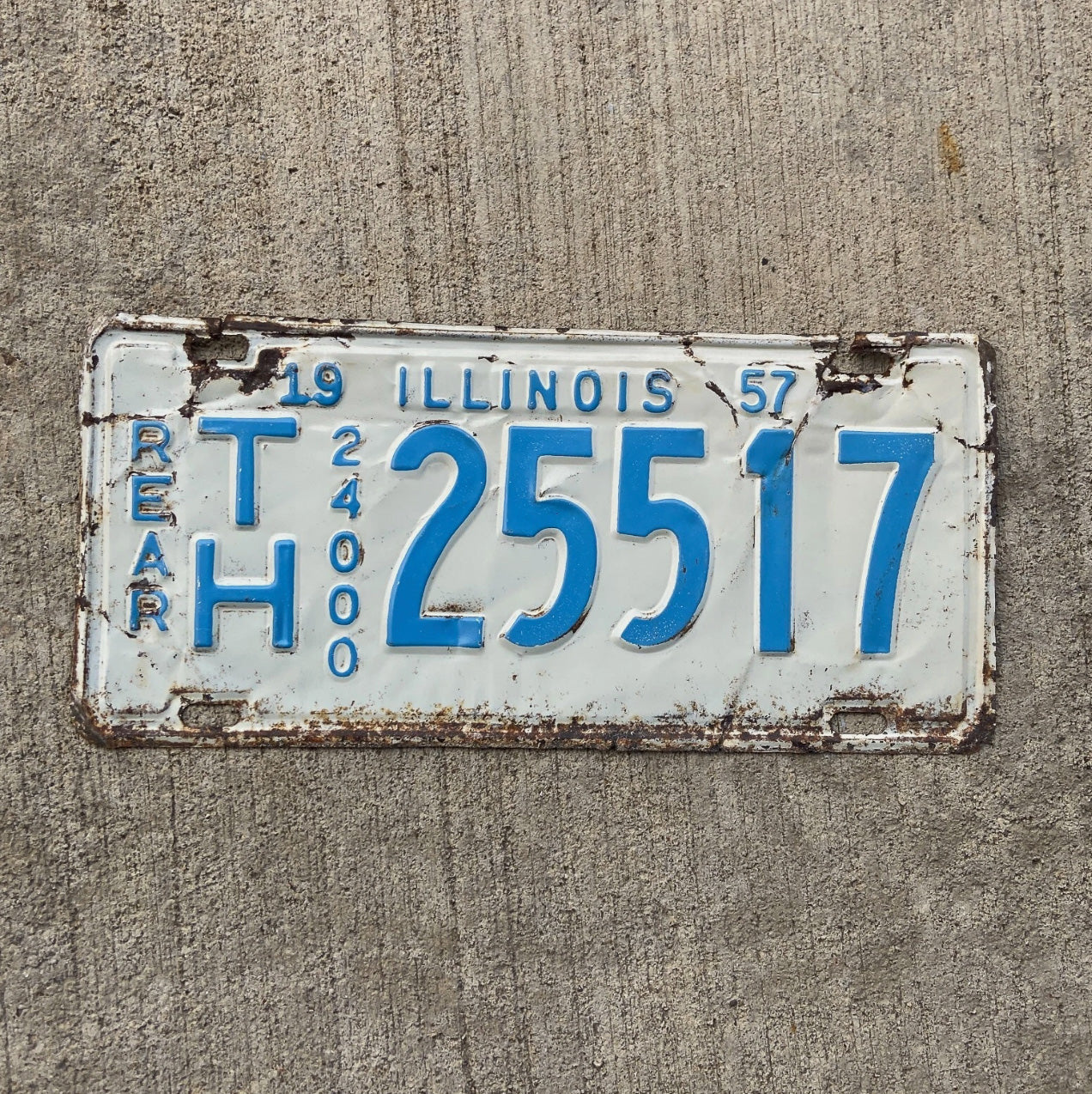 Photo of a 1957 Illinois Truck Mileage Tax License Plate Auto Tag Garage Decor Vintage Rear TH 25517 with original patina