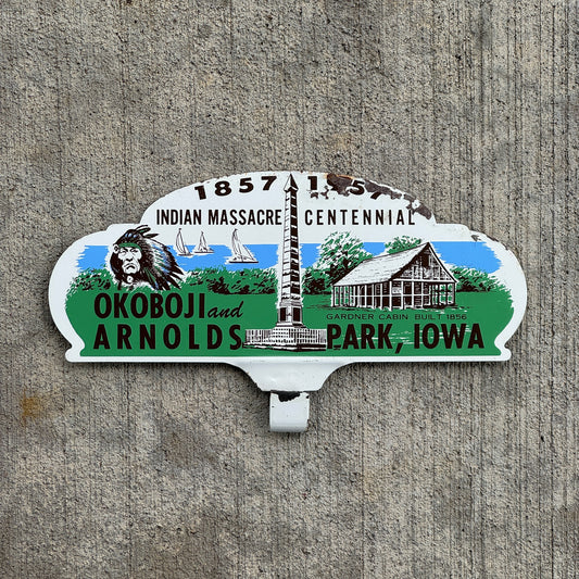 Photo of a 1957 Indian Massacre Centennial Arnolds Park Iowa License Plate Topper Auto Tag Garage Decor Vintage Okoboji with original patina