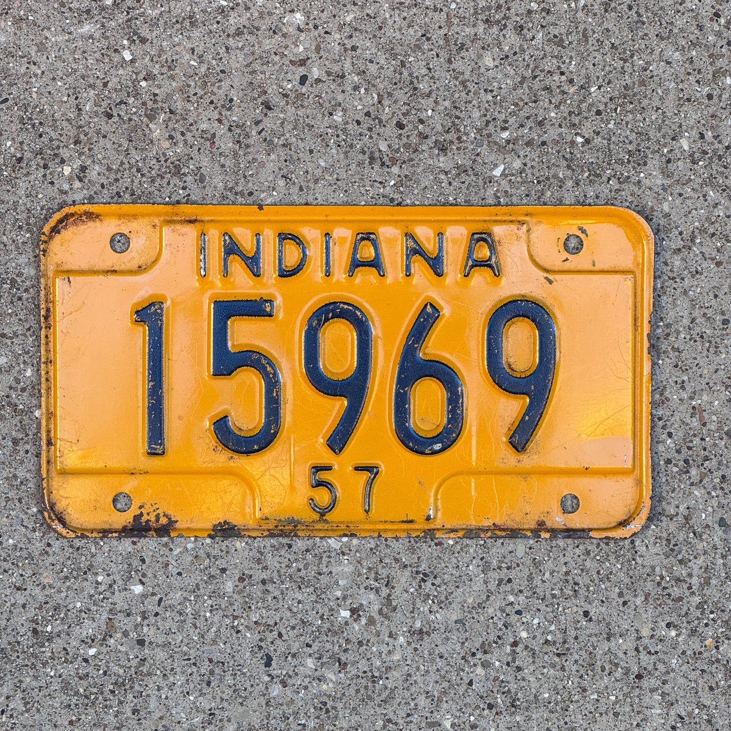 Photo of a 1957 Indiana Motorcycle License Plate Auto Tag Garage Decor Vintage 15969 with original patina