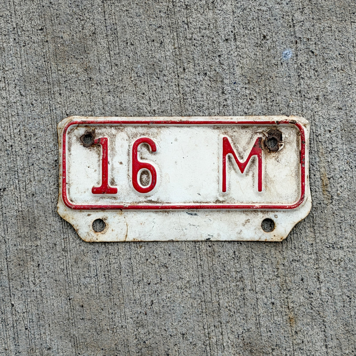 Photo of a 1957 Kansas Truck License Plate Auto Tag Garage Decor Vintage 16 M Supplementary Topper with original patina