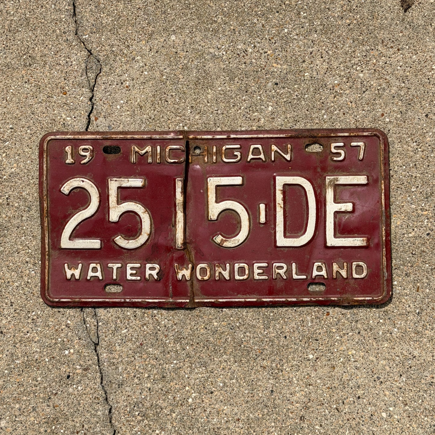 Photo of a 1957 Michigan Commercial License Plate Auto Tag Garage Decor Vintage 2515 DE with original patina