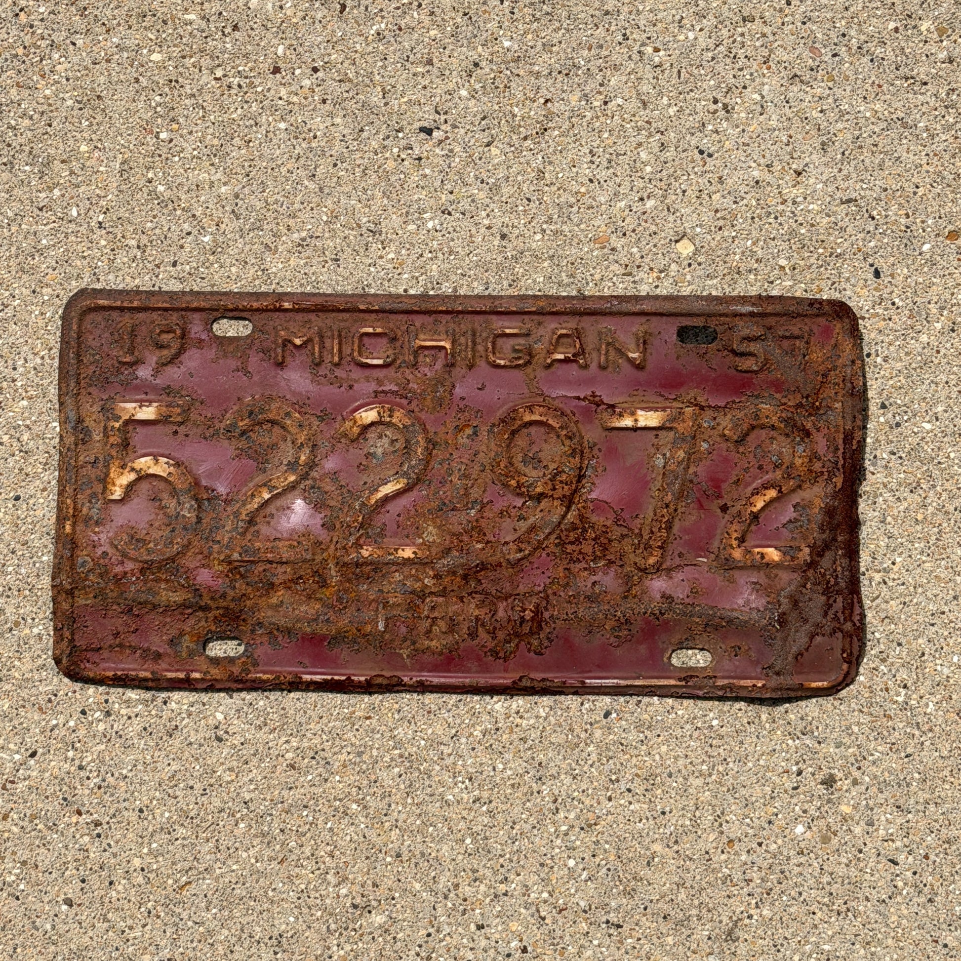 Photo of a 1957 Michigan Farm License Plate Auto Tag Garage Decor Vintage 522 972 with original patina