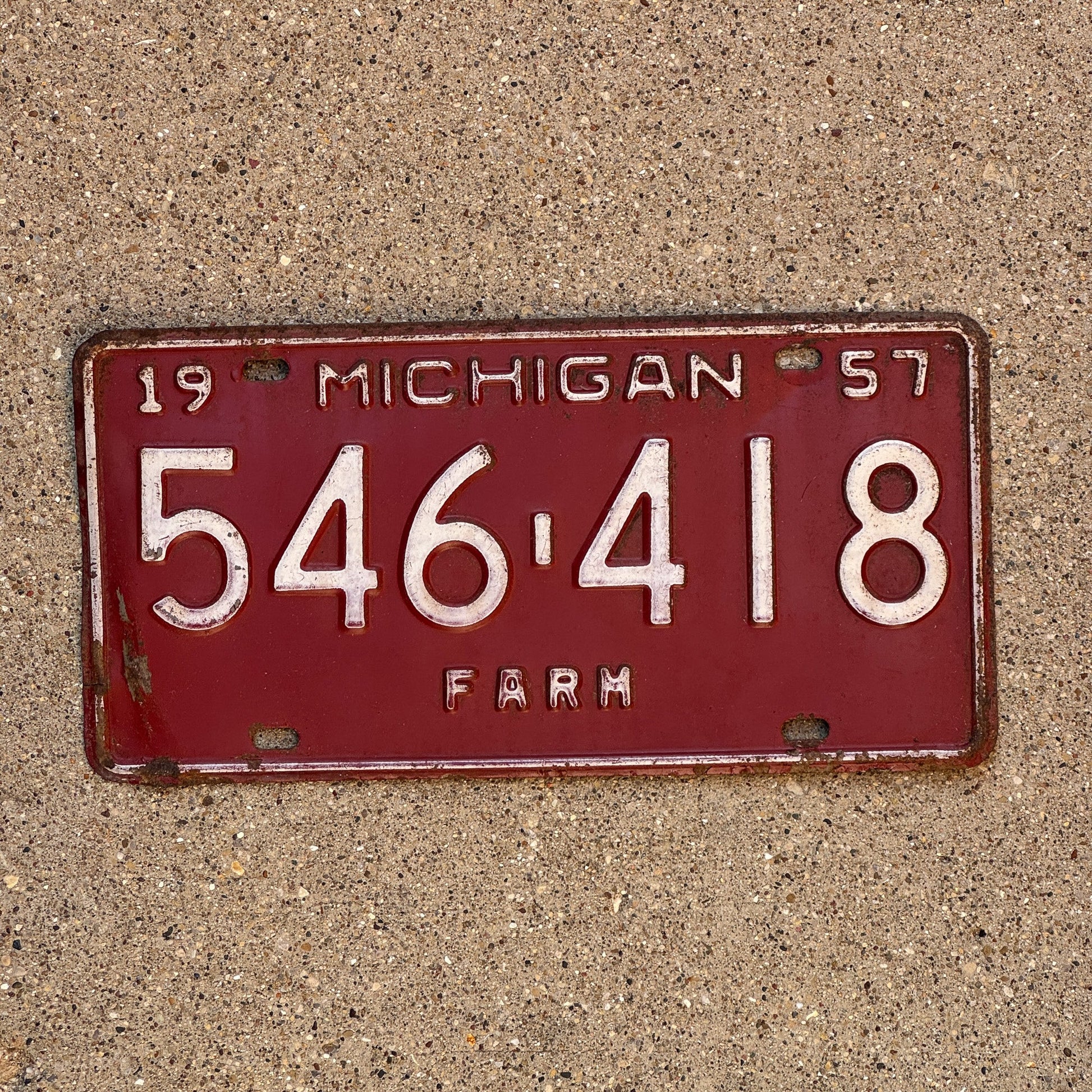 Photo of a 1957 Michigan Farm License Plate Auto Tag Garage Decor Vintage 546 418