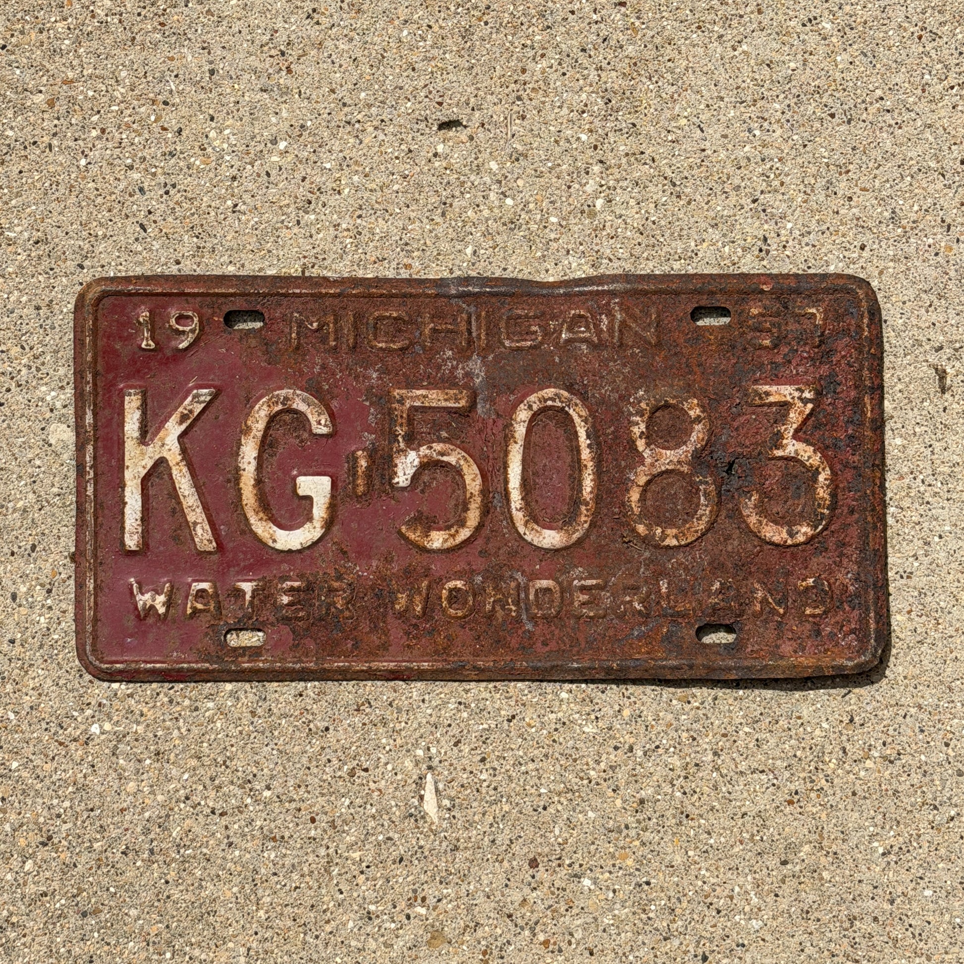 Photo of a 1957 Michigan License Plate Auto Tag Garage Decor Vintage KG 5083 with original patina