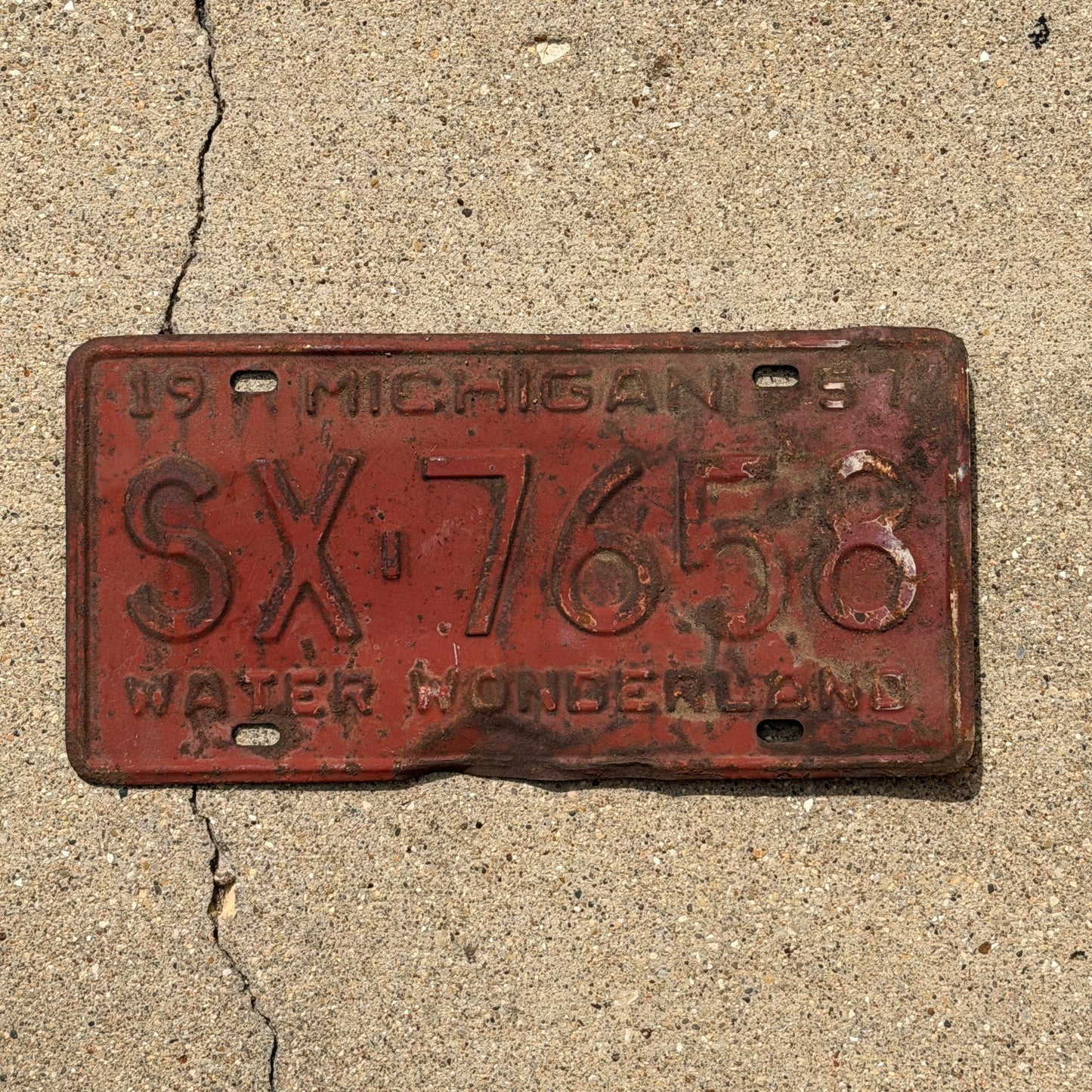Photo of a 1957 Michigan License Plate Auto Tag Garage Decor Vintage SX 7658 with original patina