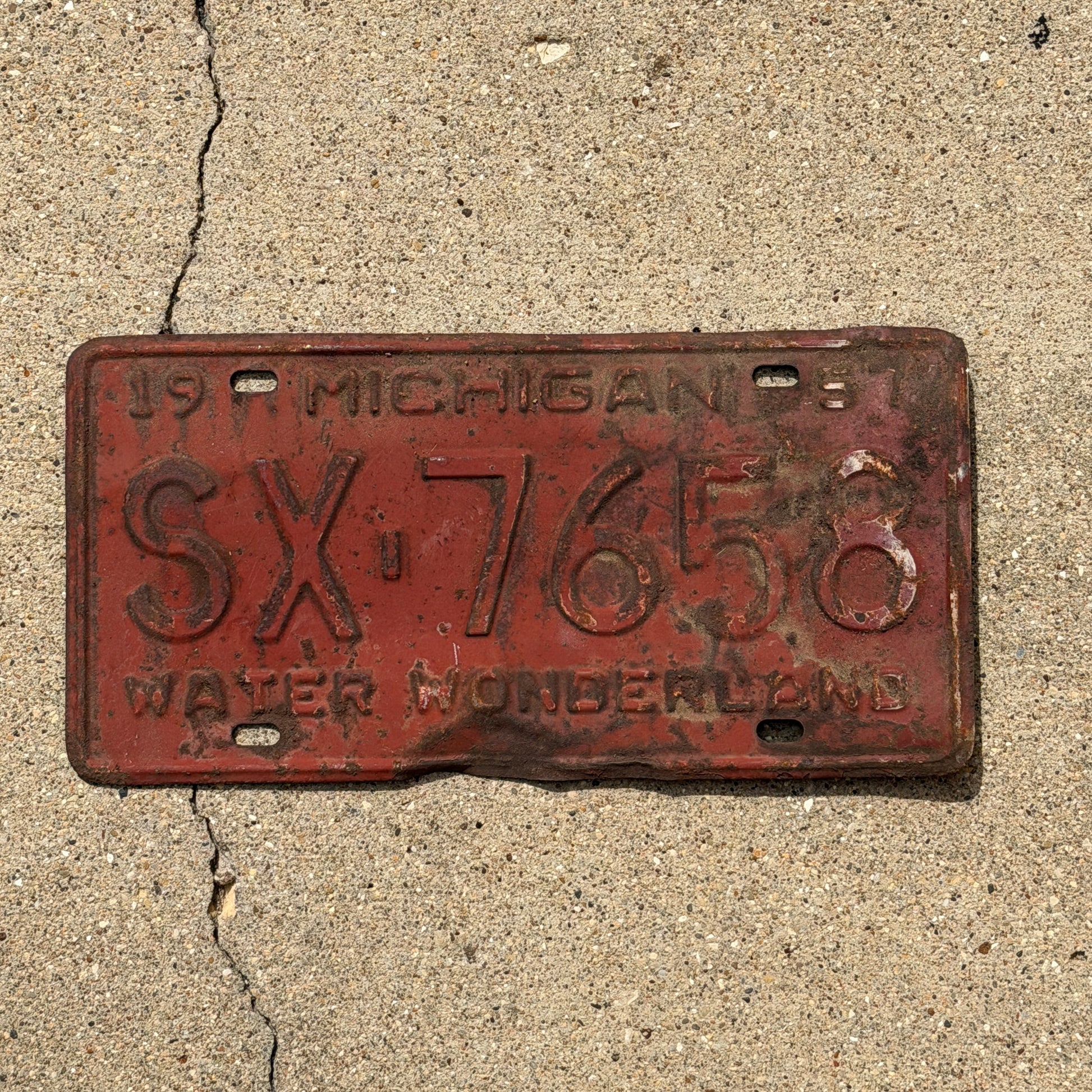Photo of a 1957 Michigan License Plate Auto Tag Garage Decor Vintage SX 7658 with original patina