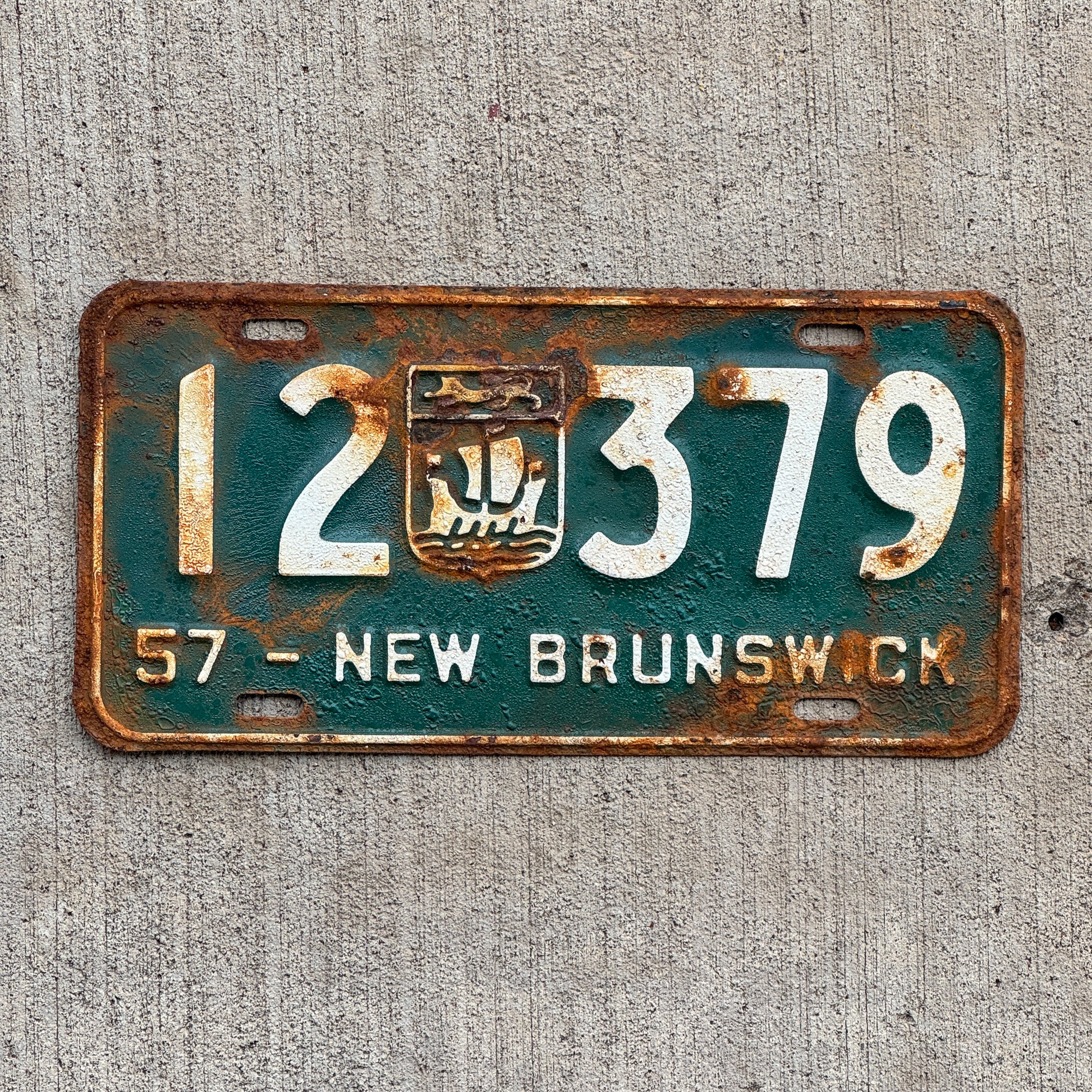 Photo of a 1957 New Brunswick License Plate Auto Tag 1 Vintage Garage Provincial Coat of Arms 12 379 with original patina