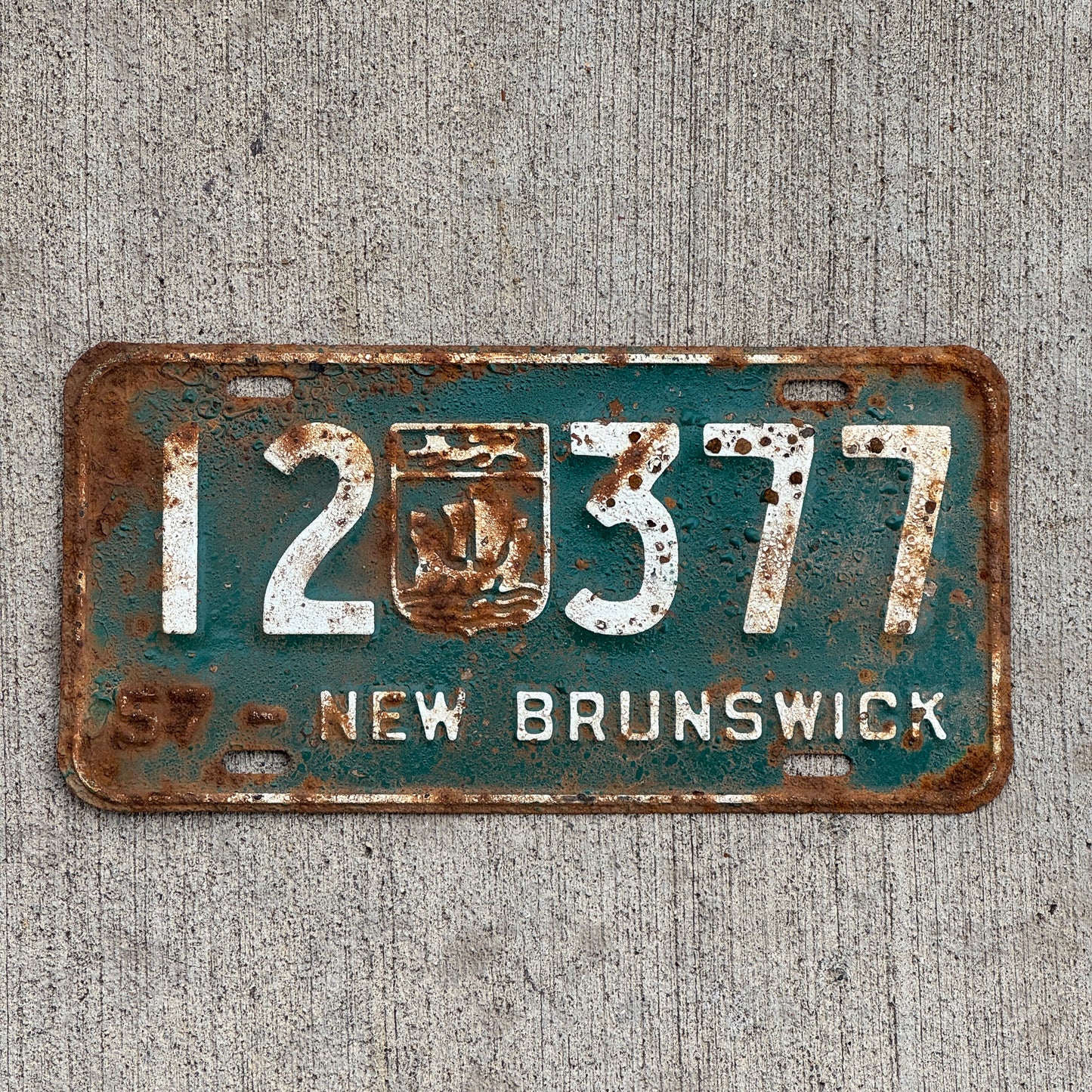 Photo of a 1957 New Brunswick License Plate Auto Tag 2 Vintage Garage Provincial Coat of Arms 12 377 with original patina