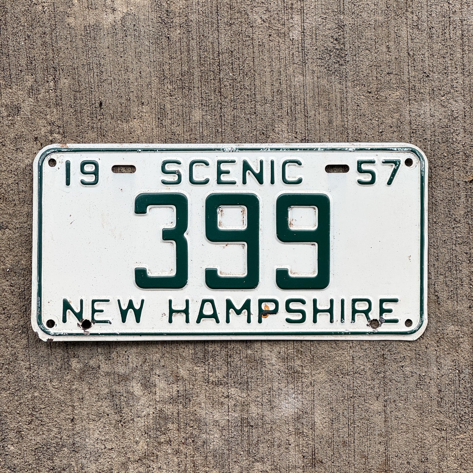 Photo of a 1957 New Hampshire License Plate Auto Tag Garage Decor Vintage Low Number Three Digit 399 with original patina
