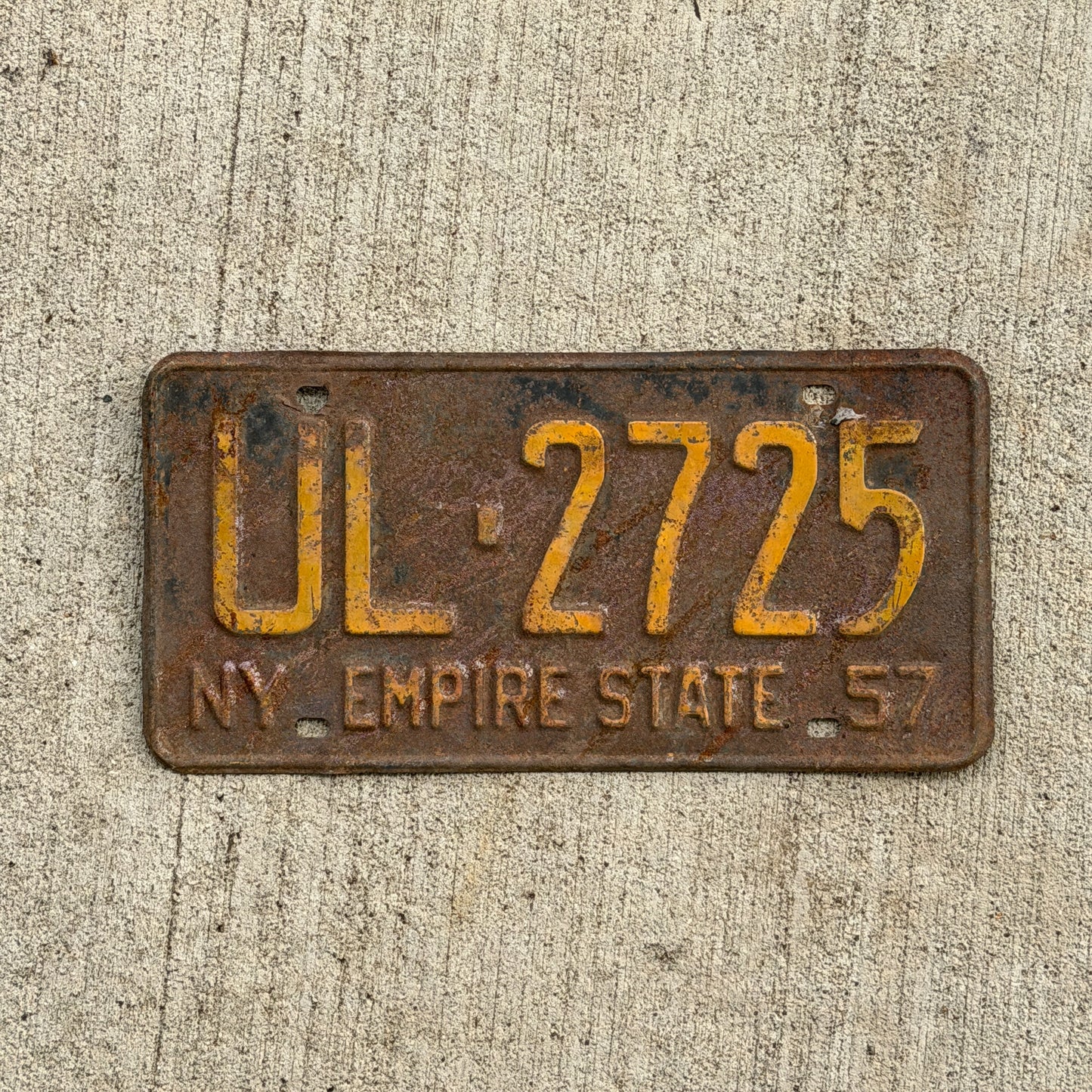 Photo of a 1957 New York License Plate Auto Tag Garage Decor Vintage UL 2725 with original patina