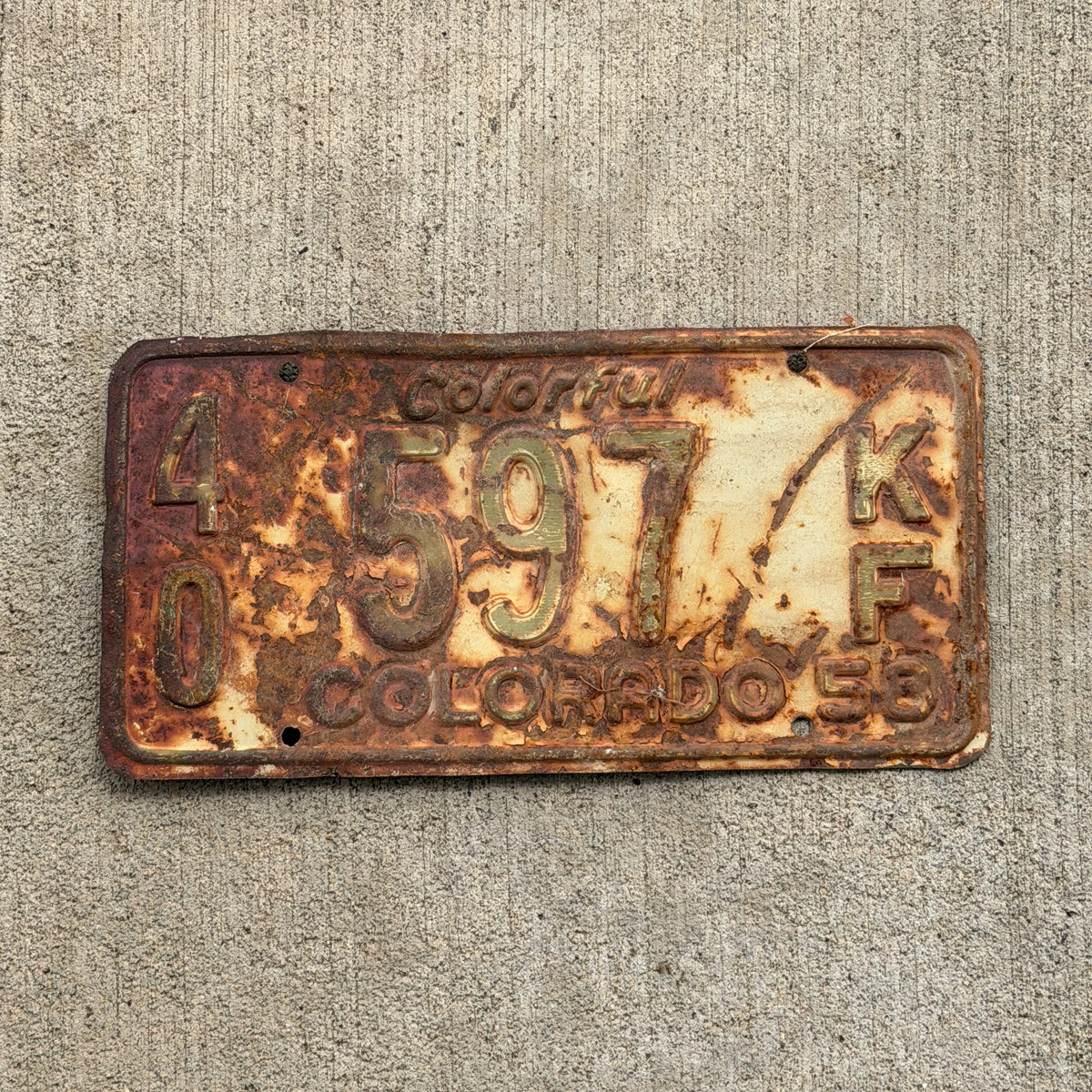Photo of a 1958 Colorado Farm Truck License Plate Auto Tag Garage Decor Vintage 40 597 KF with original patina