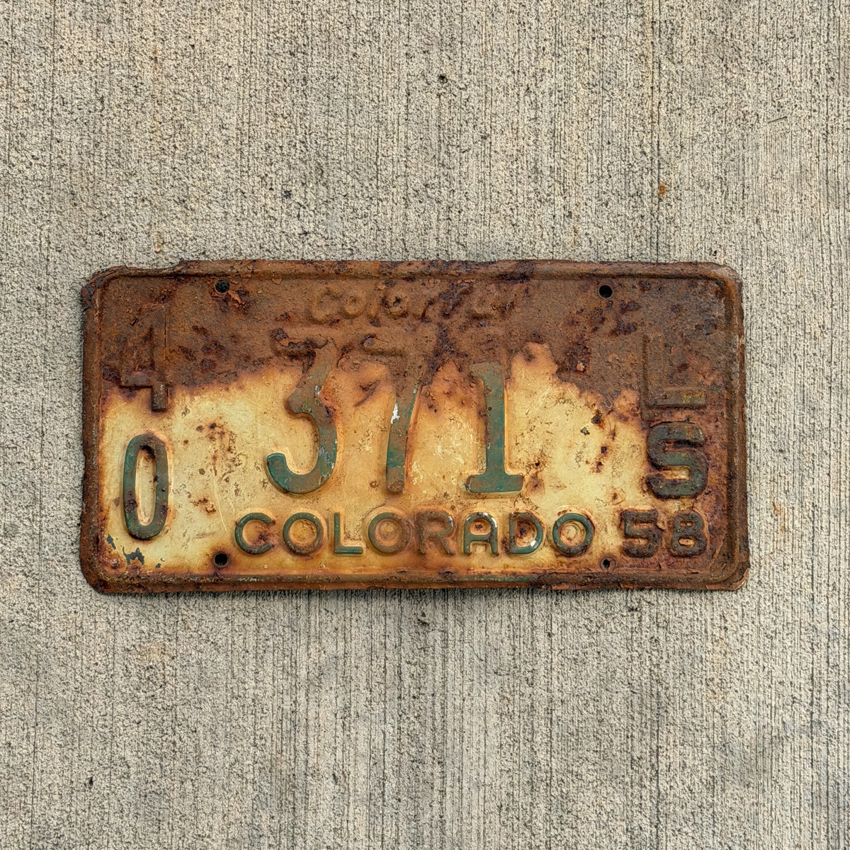Photo of a 1958 Colorado Trailer License Plate Auto Tag Garage Decor Vintage 40 371 LS with original patina