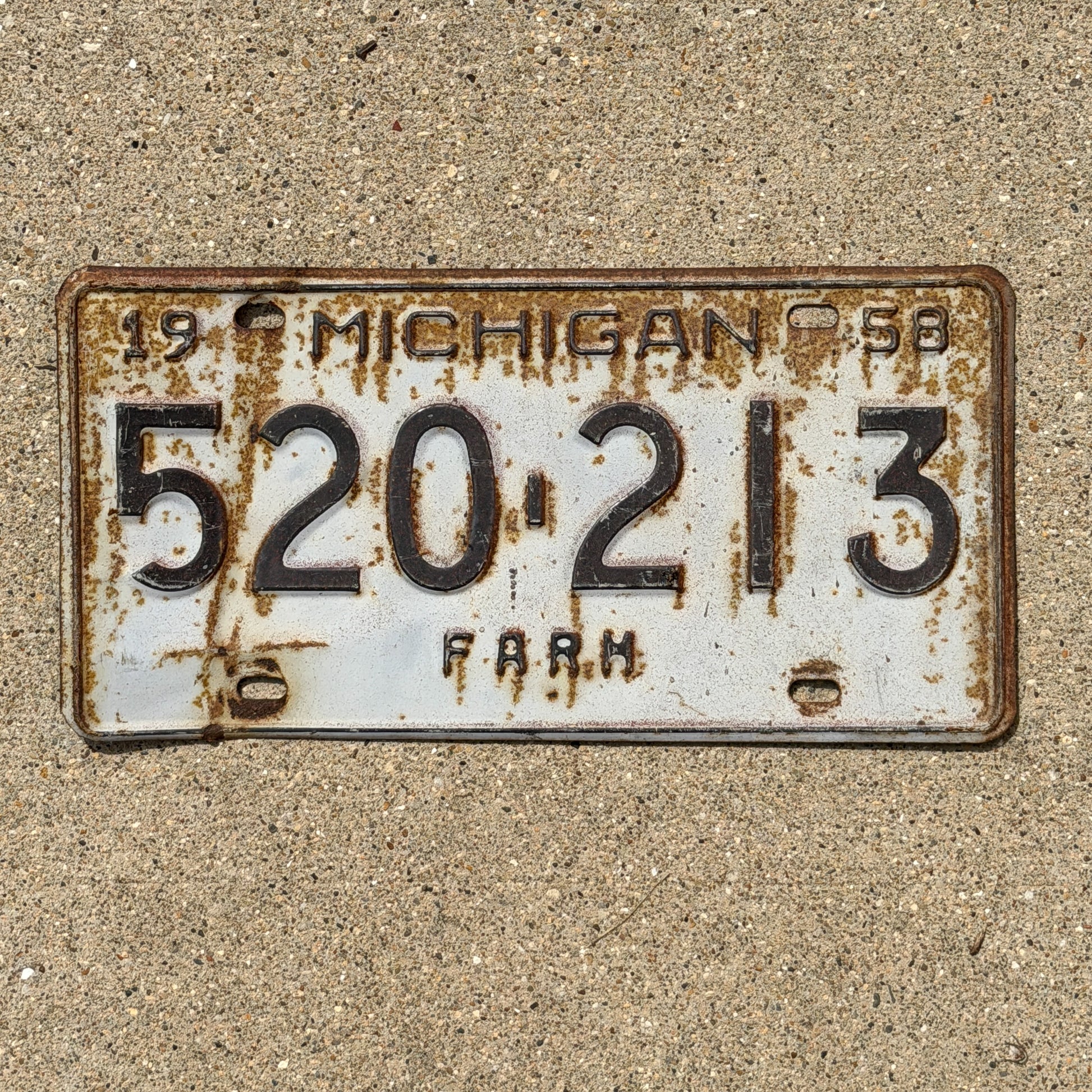 Photo of a 1958 Michigan Farm License Plate Auto Tag Garage Decor Vintage 520 213 with original patina