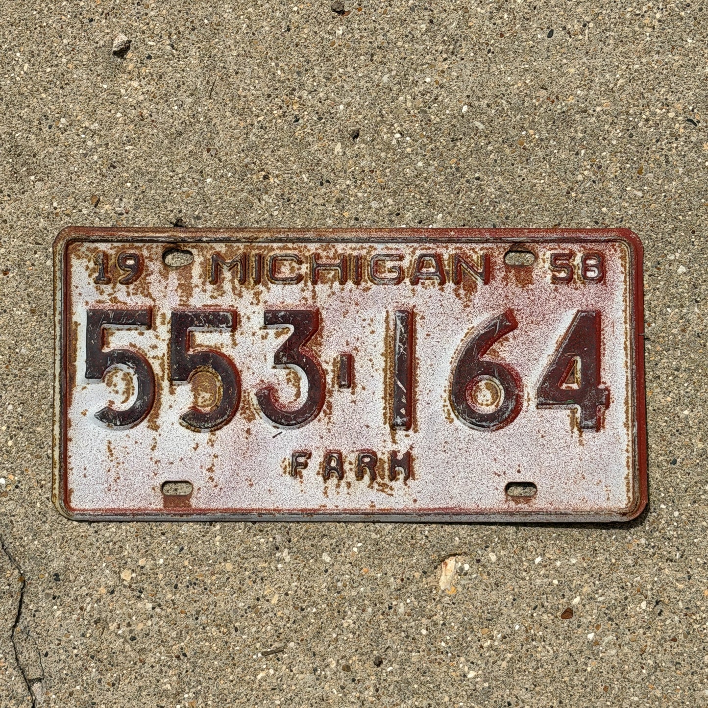 Photo of a 1958 Michigan Farm License Plate Auto Tag Garage Decor Vintage 553 164 with original patina