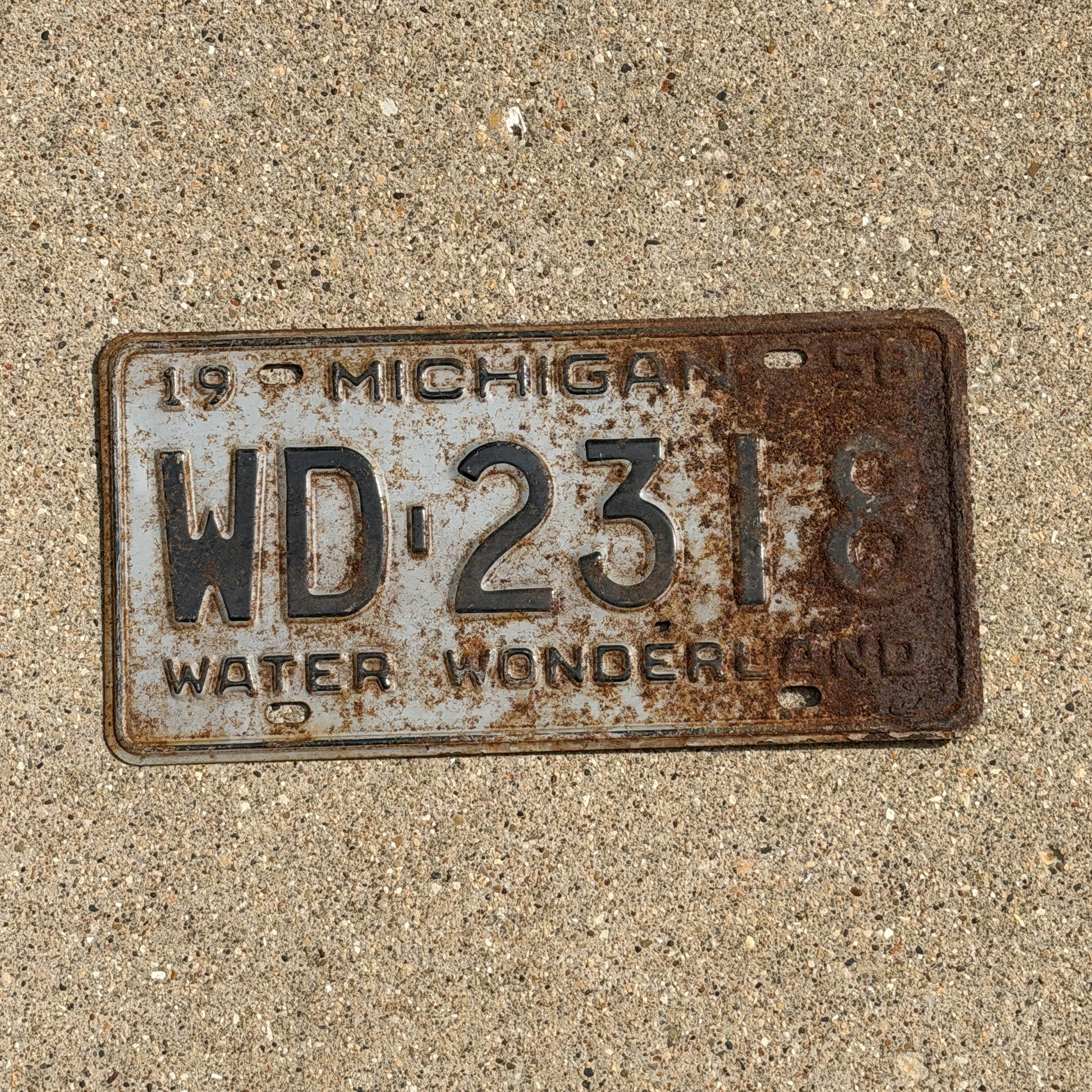 Photo of a 1958 Michigan License Plate Auto Tag 1 Vintage Garage WD 2318 with original patina