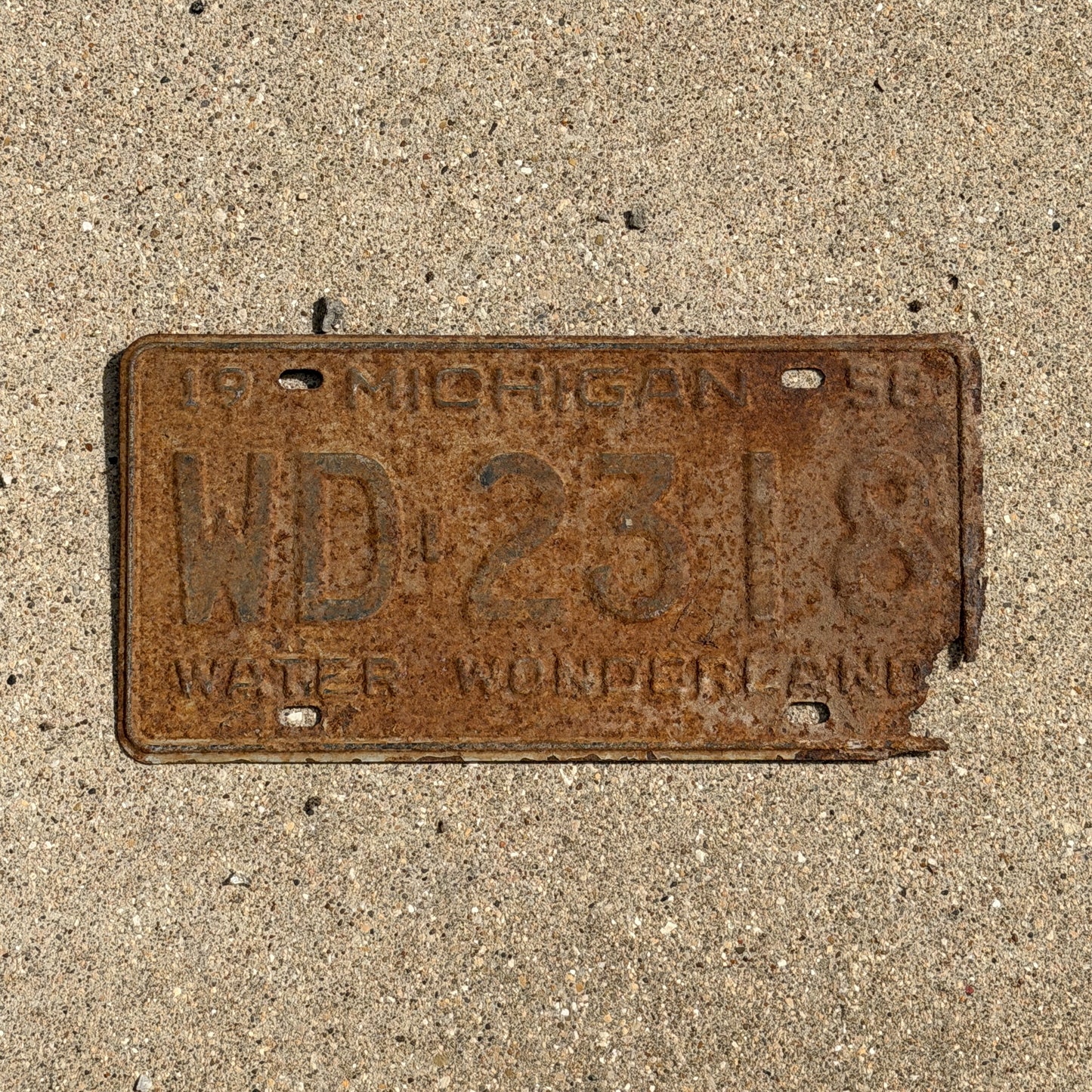 Photo of a 1958 Michigan License Plate Auto Tag 2 Vintage Garage WD 2318 with original patina