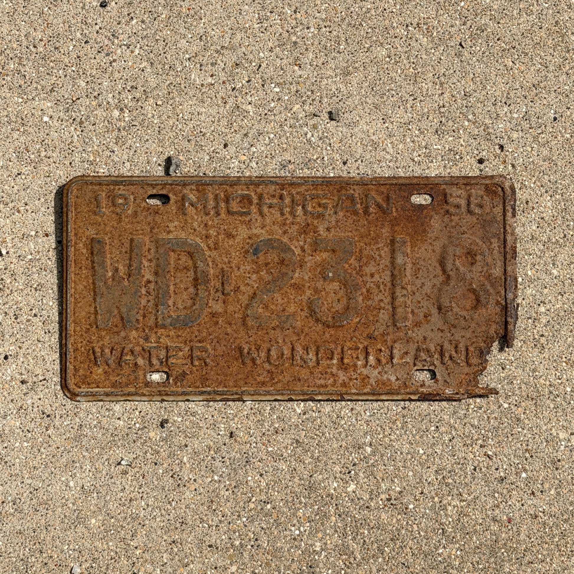 Photo of a 1958 Michigan License Plate Auto Tag 2 Vintage Garage WD 2318 with original patina