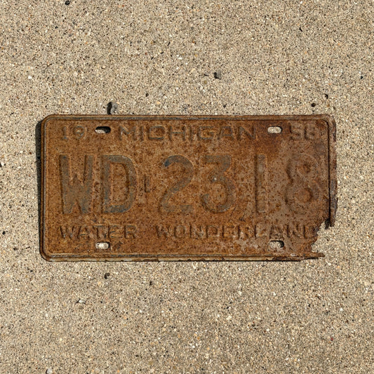 Photo of a 1958 Michigan License Plate Auto Tag 2 Vintage Garage WD 2318 with original patina