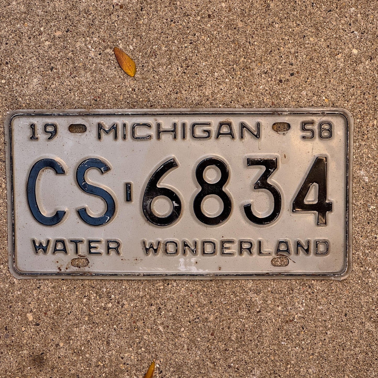 Photo of a 1958 Michigan License Plate Auto Tag Garage Decor Vintage CS 6834 with original patina