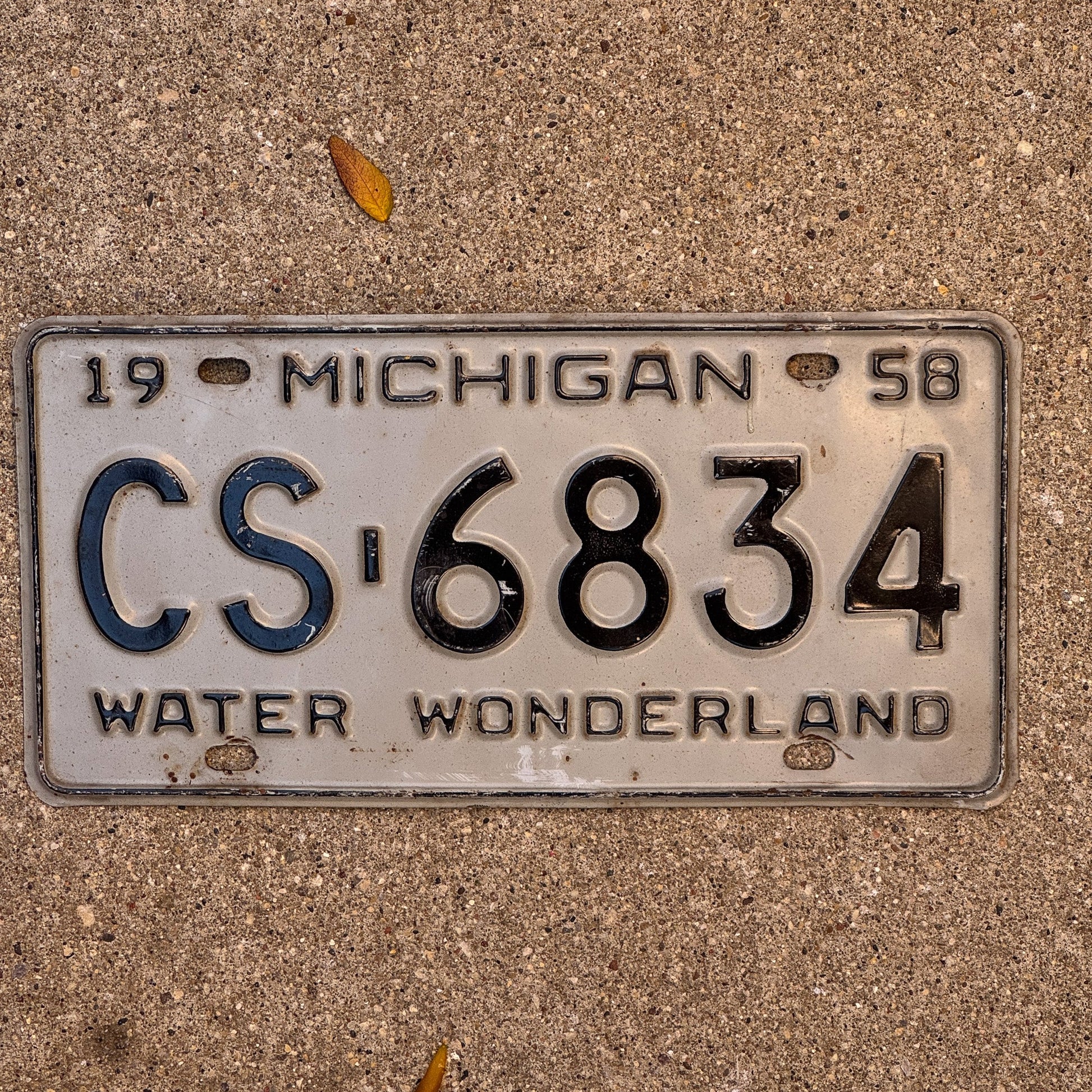 Photo of a 1958 Michigan License Plate Auto Tag Garage Decor Vintage CS 6834 with original patina