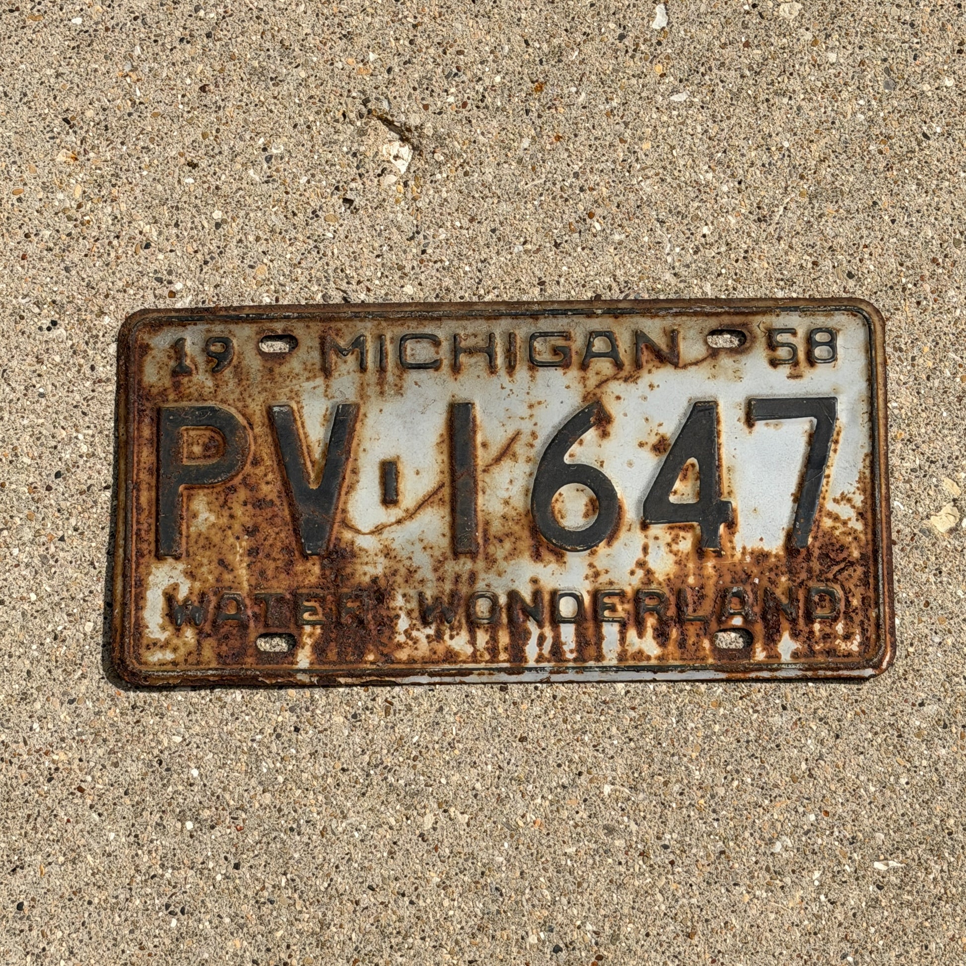 Photo of a 1958 Michigan License Plate Auto Tag Garage Decor Vintage PV 1647 with original patina