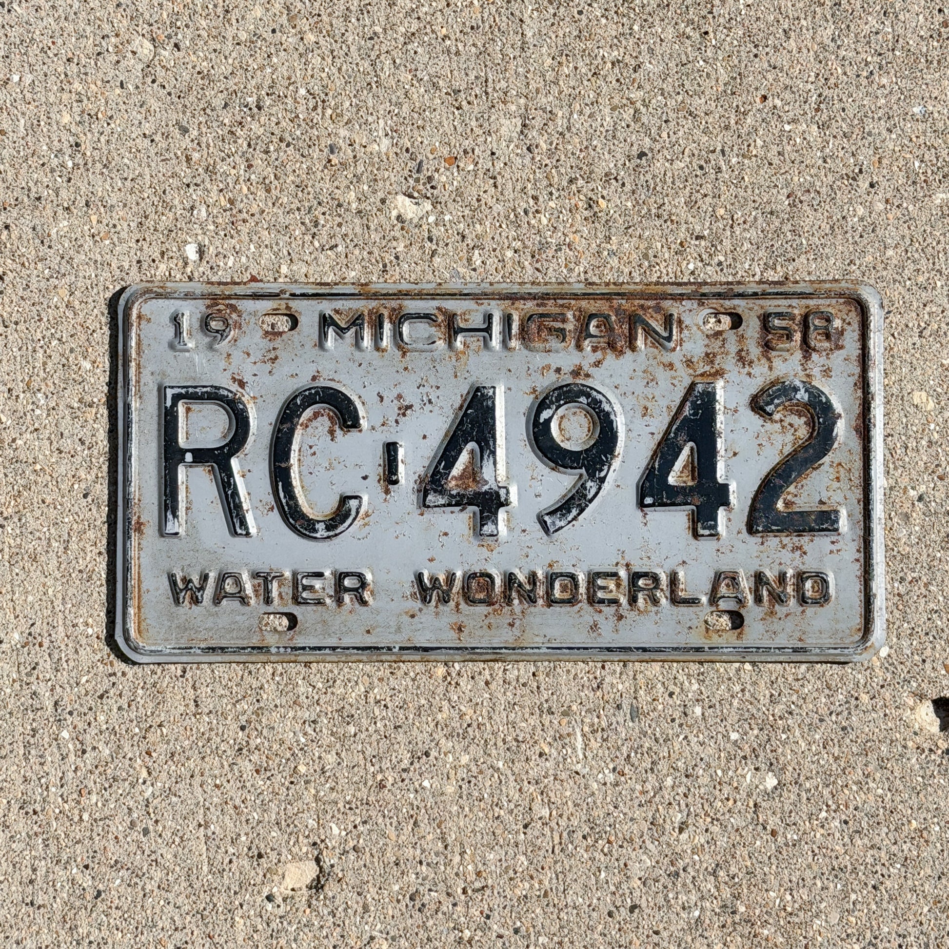 Photo of a 1958 Michigan License Plate Auto Tag Garage Decor Vintage RC 4942 with original patina