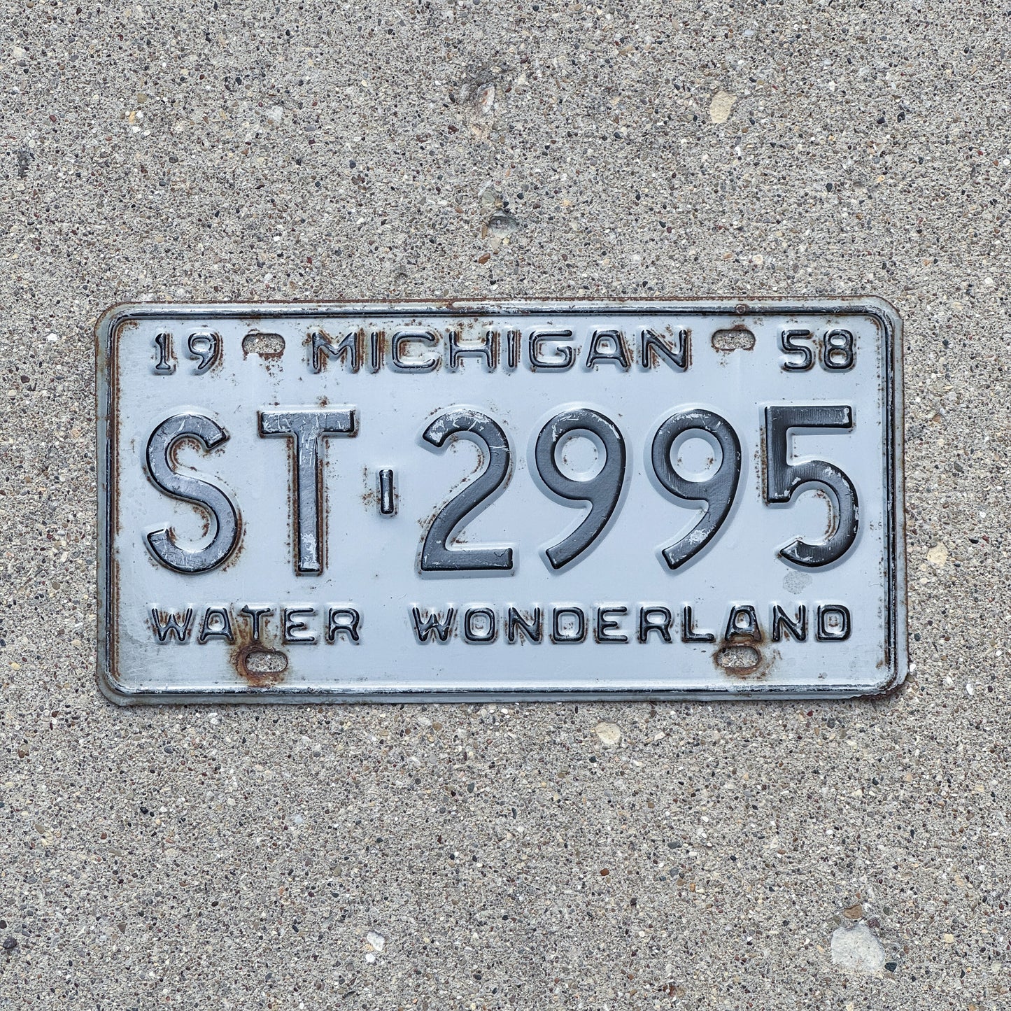 Photo of a 1958 Michigan License Plate Auto Tag Garage Decor Vintage ST 2995 with original patina