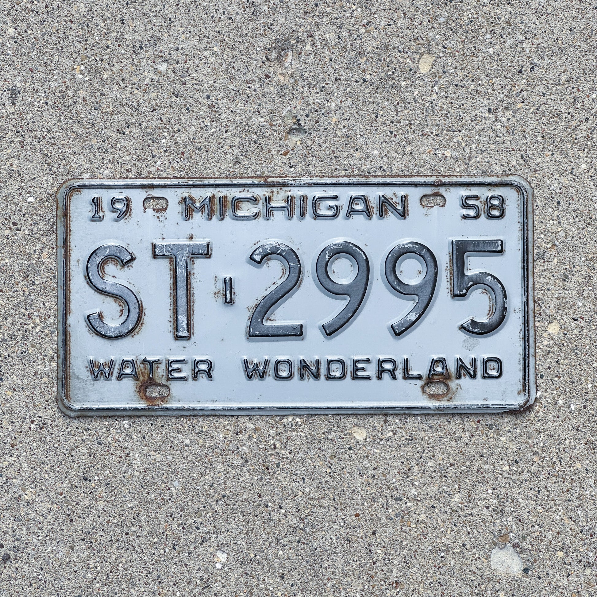 Photo of a 1958 Michigan License Plate Auto Tag Garage Decor Vintage ST 2995 with original patina