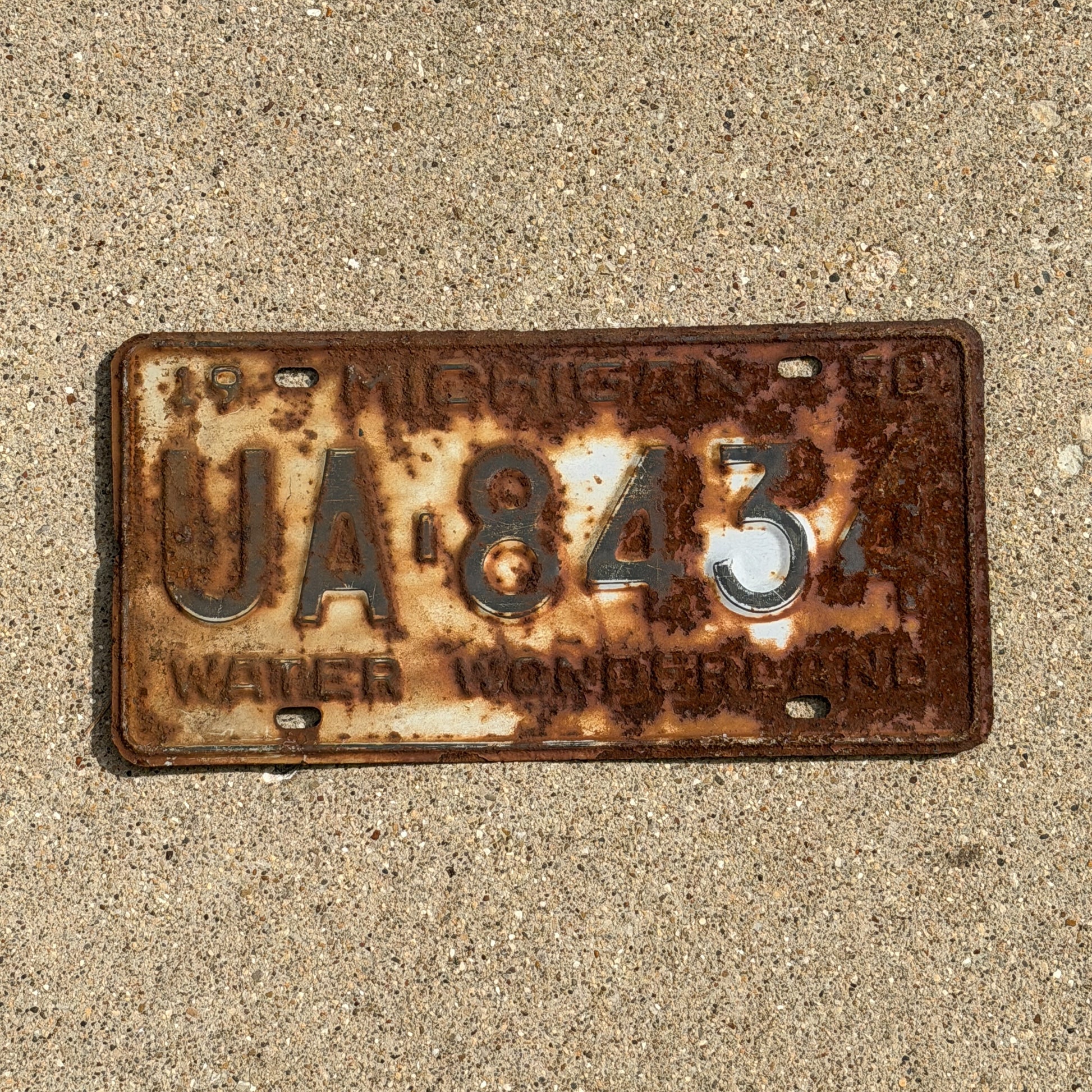 Photo of a 1958 Michigan License Plate Auto Tag Garage Decor Vintage UA 8434 with original patina
