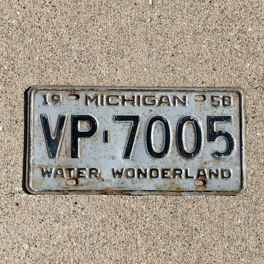 Photo of a 1958 Michigan License Plate Auto Tag Garage Decor Vintage VP 7005 with original patina