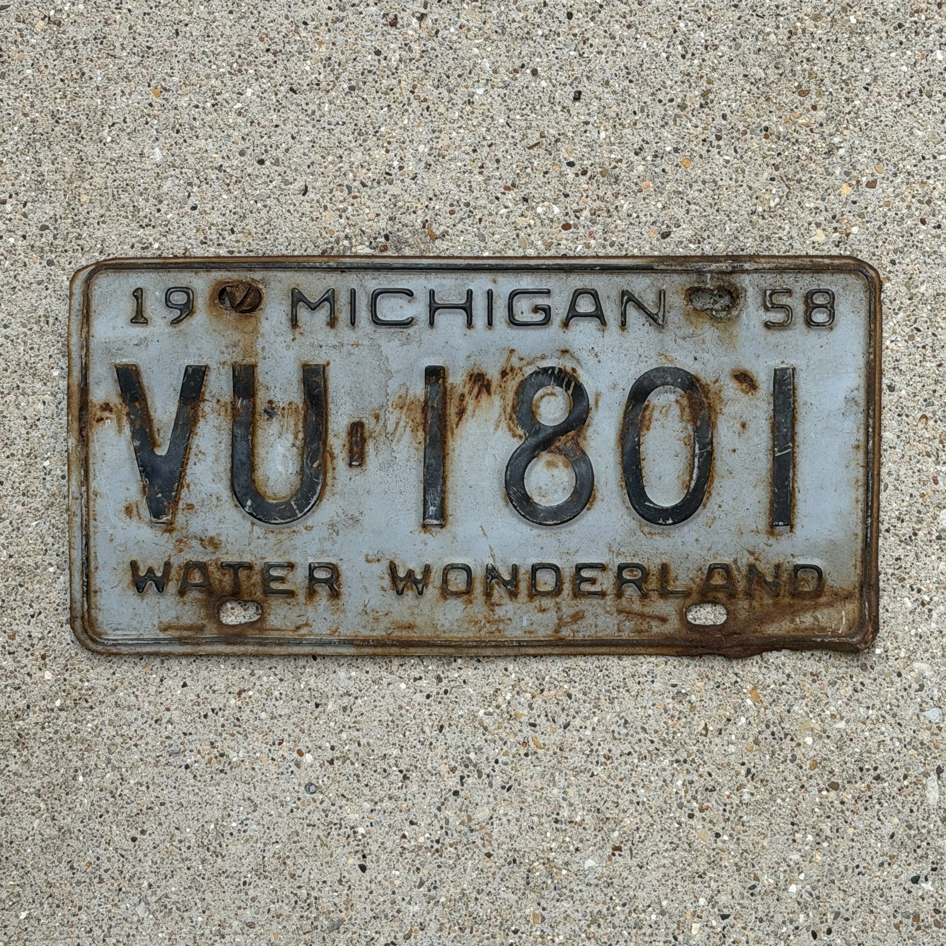 Photo of a 1958 Michigan License Plate Auto Tag Garage Decor Vintage VU 1801 with original patina