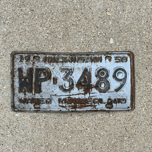 Photo of a 1958 Michigan License Plate Auto Tag Garage Decor Vintage WP 3489 with original patina