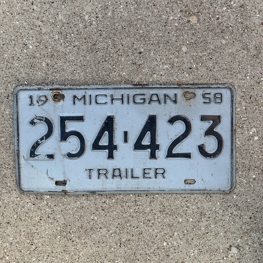 Photo of a 1958 Michigan Trailer License Plate Auto Tag Garage Decor Vintage 254 423