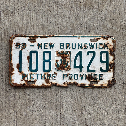 Photo of a 1958 New Brunswick License Plate Auto Tag Garage Decor Vintage Provincial Coat of Arms 108 429 with original patina