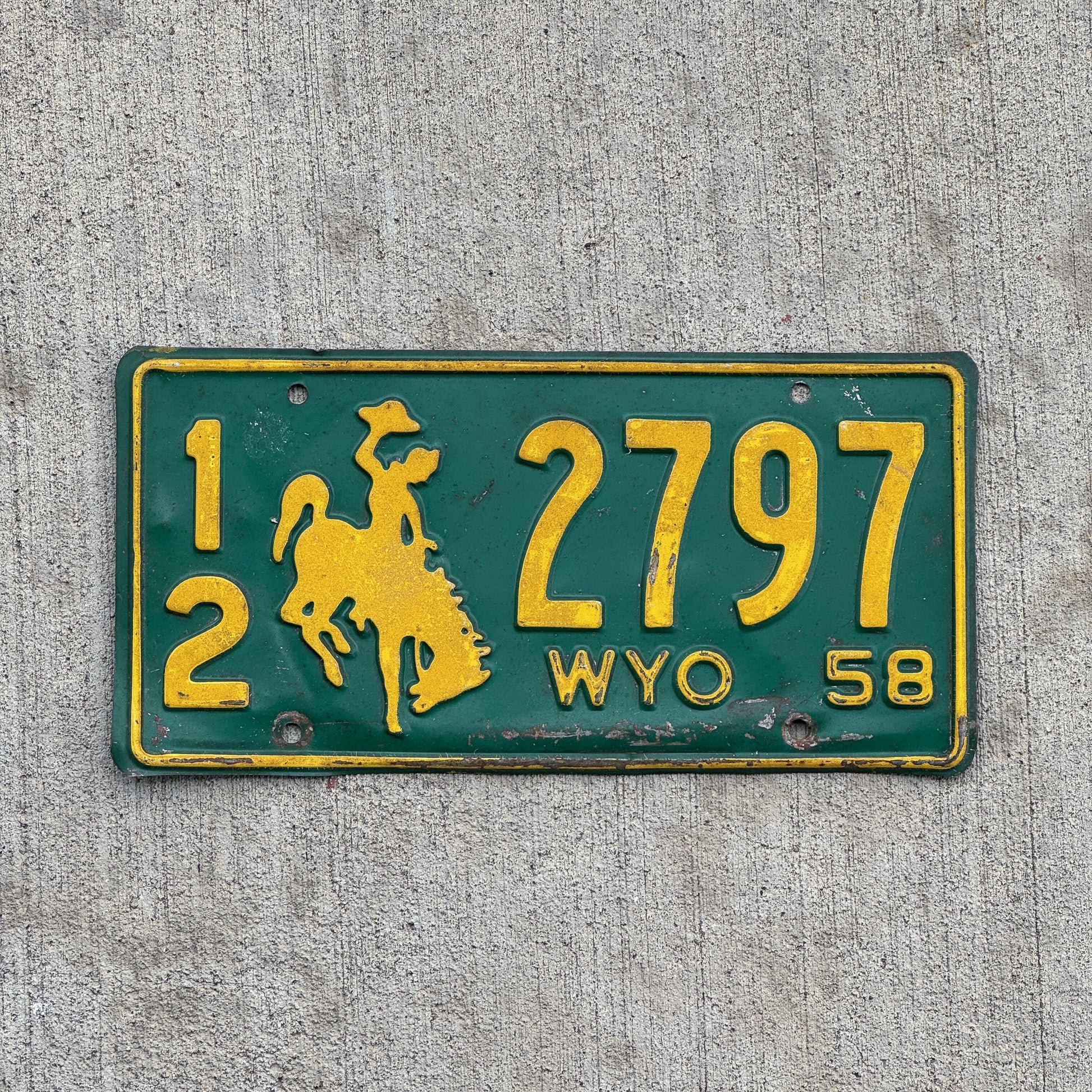 Photo of a 1958 Wyoming License Plate Auto Tag Garage Decor Vintage Cowboy Rodeo 12 2797 with original patina