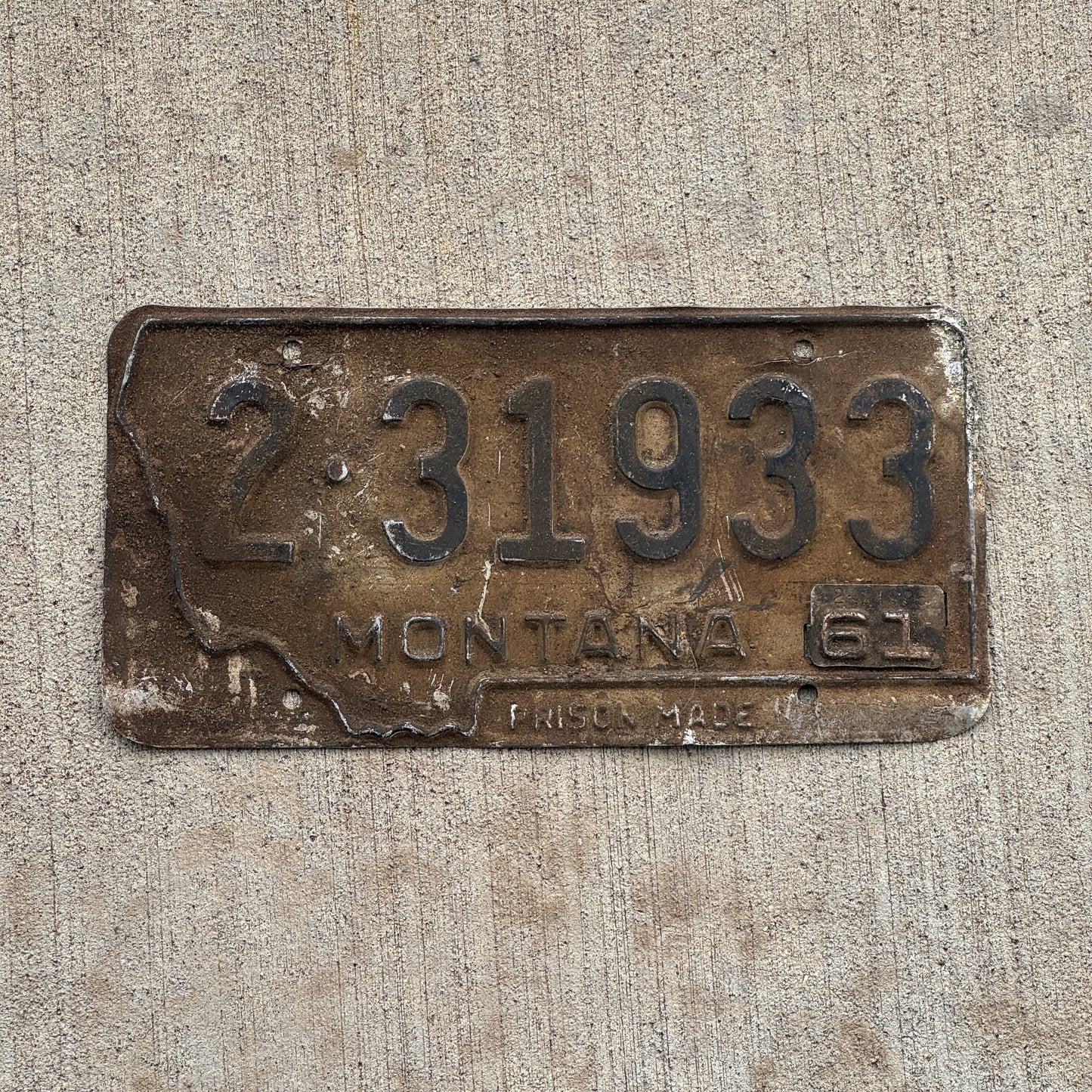 Photo of a 1959 1961 Montana License Plate Auto Tag Garage Decor Vintage State Shape Prison Made 2 31933 with original patina