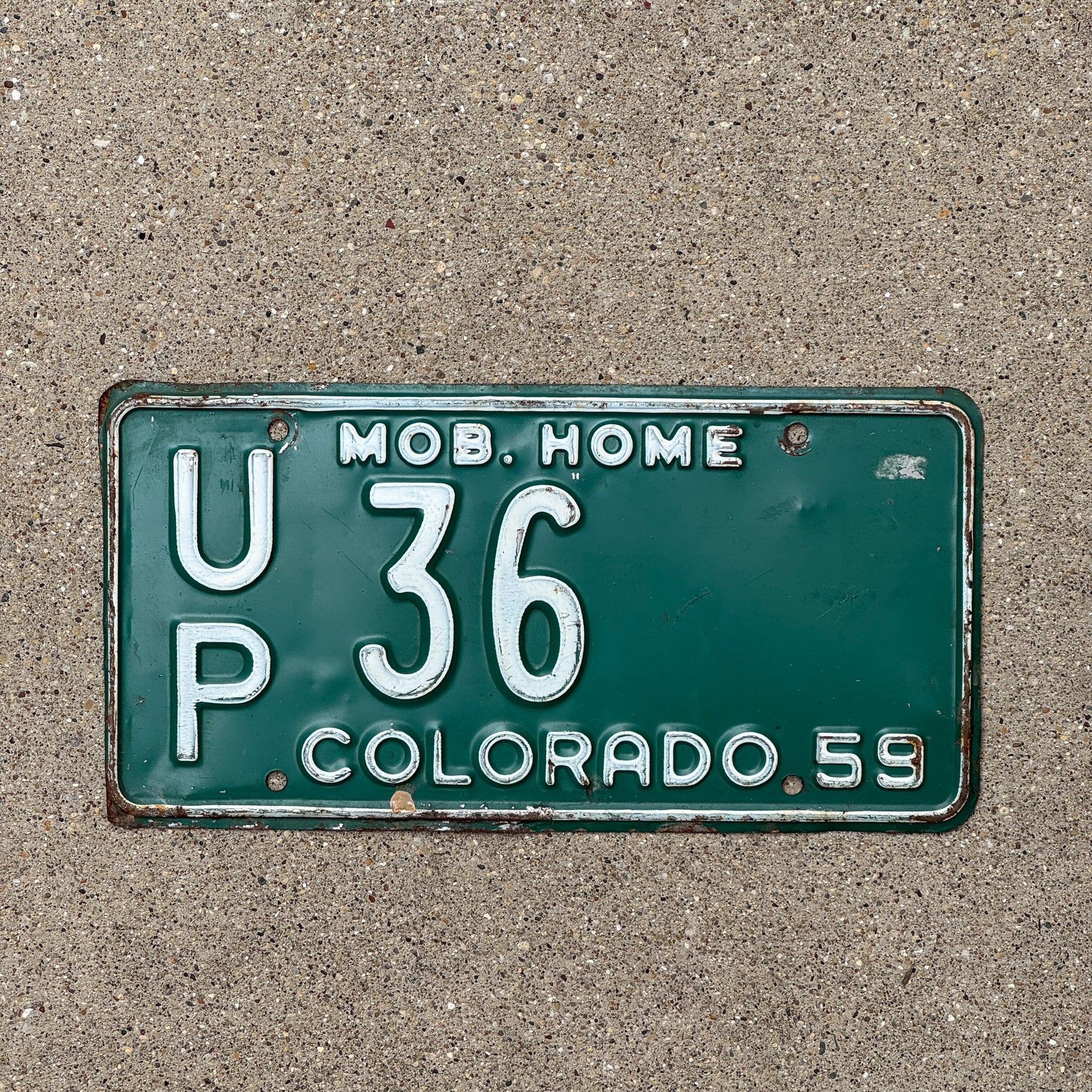Photo of a 1959 Colorado Mobile Home License Plate Auto Tag Garage Decor Vintage UP 36