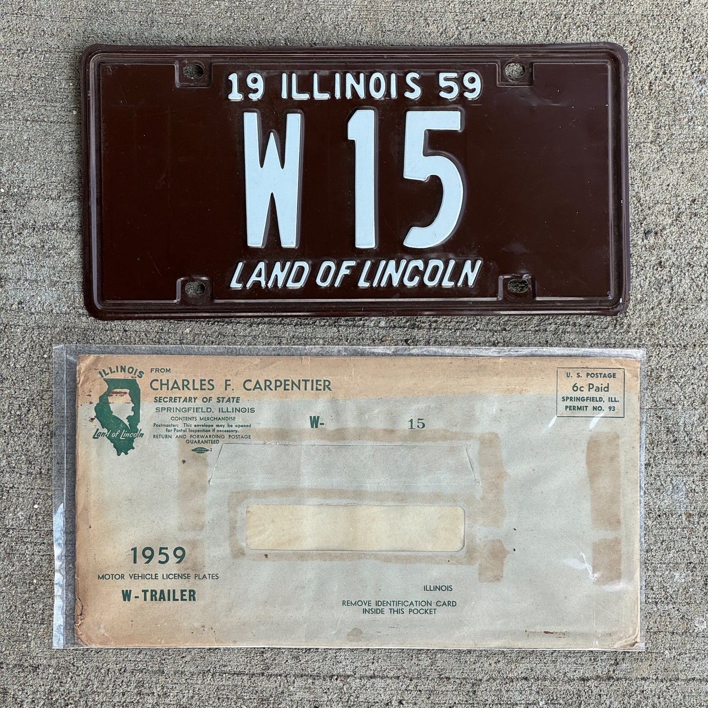Photo of a 1959 Illinois Trailer License Plate Auto Tag Garage Decor Vintage Low Number Two Digit with Envelope W 15 with original patina