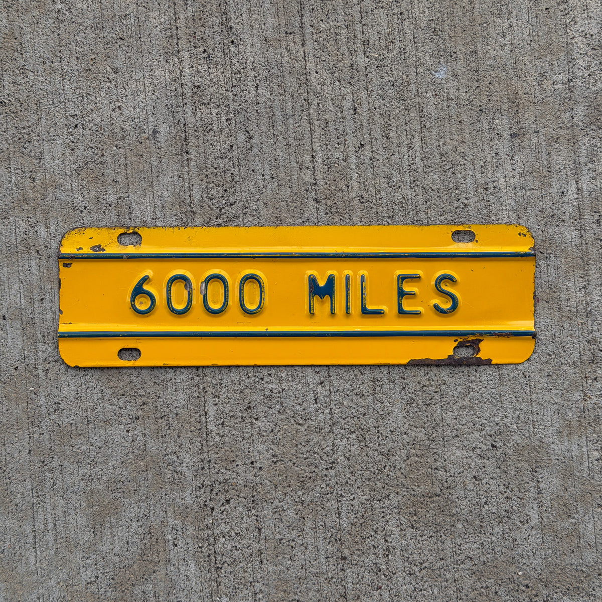 Photo of a 1959 Kansas Truck License Plate Auto Tag Garage Decor Vintage 6000 Miles Supplementary Topper with original patina