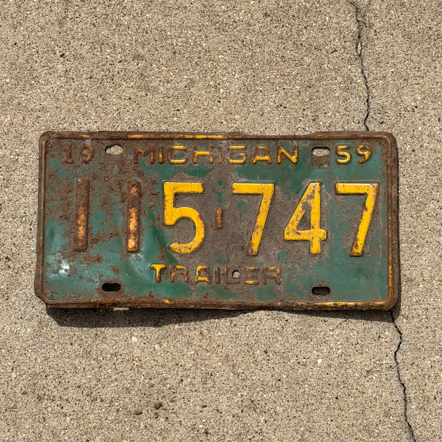 Photo of a 1959 Michigan Trailer License Plate Auto Tag Garage Decor Vintage 115 747 with original patina