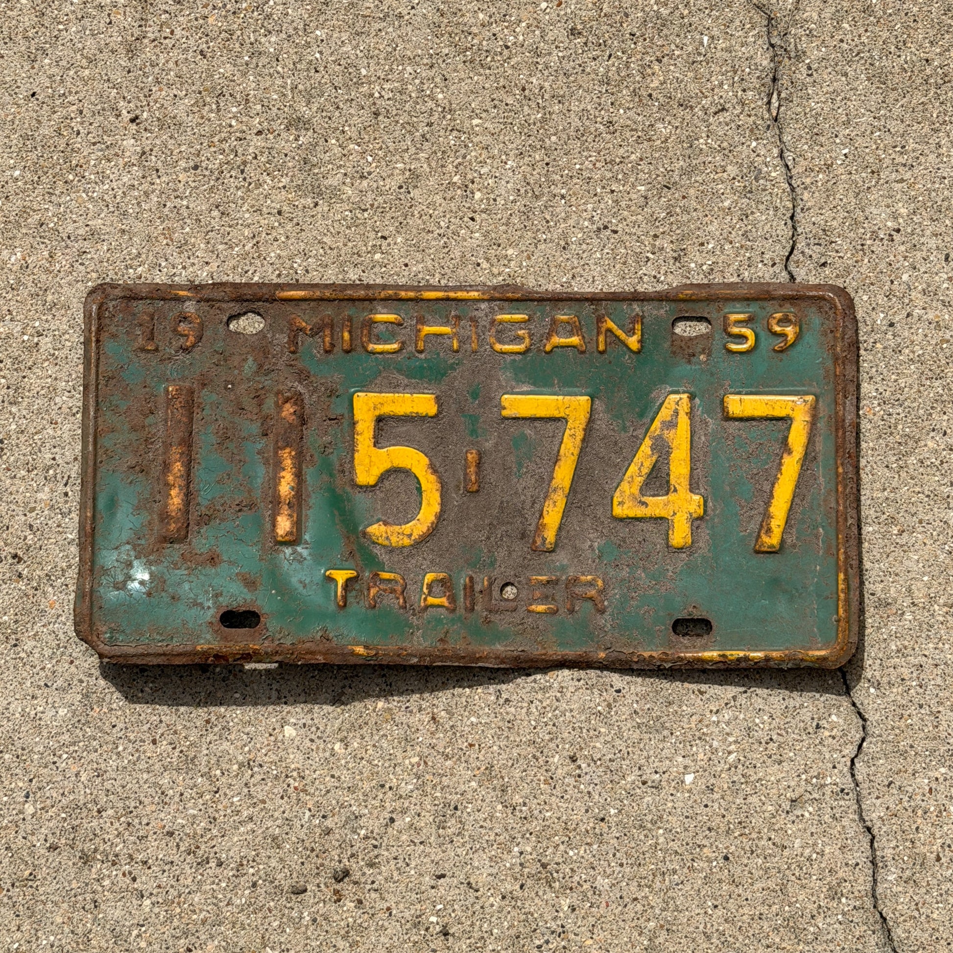 Photo of a 1959 Michigan Trailer License Plate Auto Tag Garage Decor Vintage 115 747 with original patina