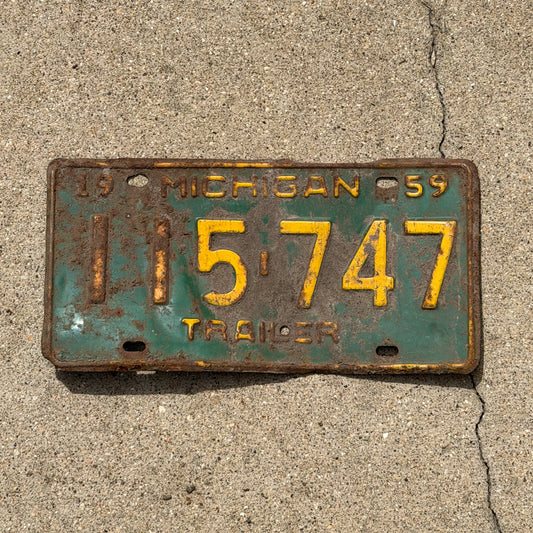 Photo of a 1959 Michigan Trailer License Plate Auto Tag Garage Decor Vintage 115 747 with original patina