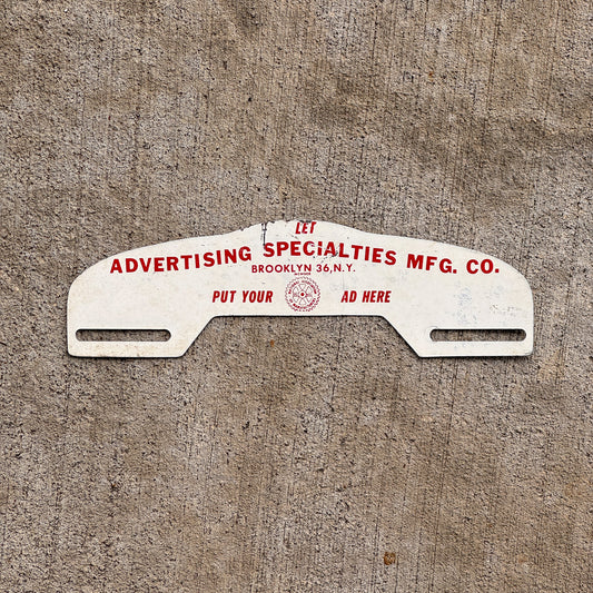 Photo of a 1960 Era Advertising Spcialties Mfg Co Brooklyn New York License Plate Topper Auto Tag Garage Decor Vintage with original patina