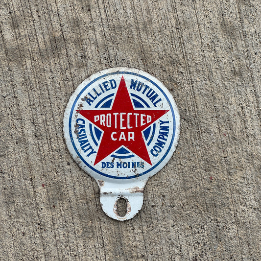 Photo of a 1960 Era Allied Mutual Insurance Des Moines Iowa License Plate Topper Auto Tag Garage Decor Vintage with original patina