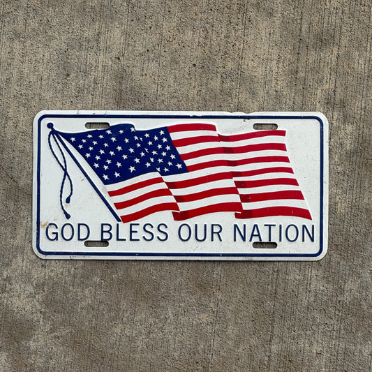 Photo of a 1960 Era American Flag Booster License Plate Auto Tag Garage Decor Vintage
 God Bless Our Nation Metal with original patina